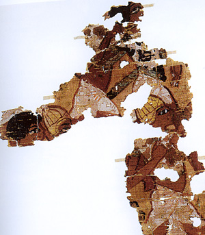 The British Museum has acquired some 40 fragments of a painted papyrus from Amarna (inv. no. EA 74100) with a unique representation of a battle. It was found in 1936 in a building which was probably a chapel dedicated to the cult of a king. The battle scene is preserved in two main areas. The first scene shows a group of Libyan archers attacking an Egyptian, while the second shows a group of running warriors, arranged in two overlapping registers. There is a very fragmentary third scene with similar figures. All the soldiers wear white kilts typical of Egyptian troops. Some wear helmet similar to Egyptian representation of gurpisu helmets worn by Asiatics. These helmets may actually have represented Achaean boar's tusk helmets. Some of the soldiers wear oxhide tunics which may have been lined with metal strips. This too is compatible with Achaean depictions of warriors.